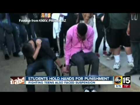 Two male high school students forced to hold hands as punishment