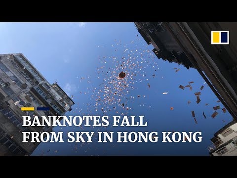 Banknotes falling from the sky send crowd into a frenzy in Hong Kong