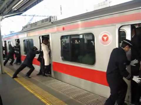 People stuffed onto a train in Tokyo, Japan (train stuffing Tokyo)