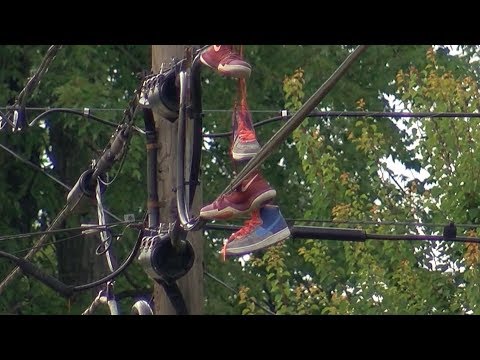 SHOES HANGING ON POWER LINES