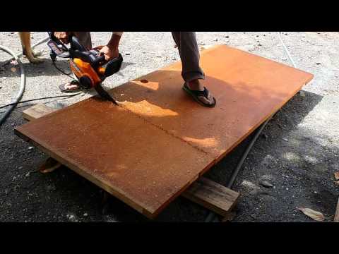Cutting old door using chain saw for disposal