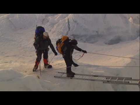 Erik crosses a ladder that spans a crevasse