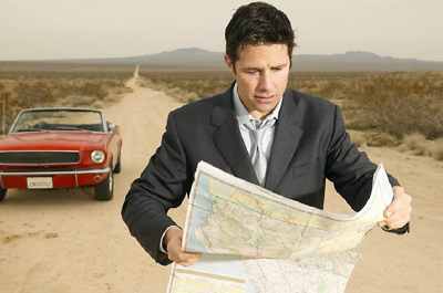Man Looking At A Map While Stopped On A Country Road Uid 1