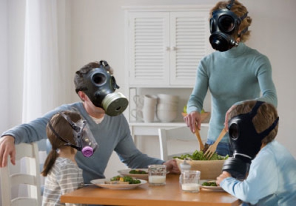Family indoors wearing gasmasks to survive the poor-quality air