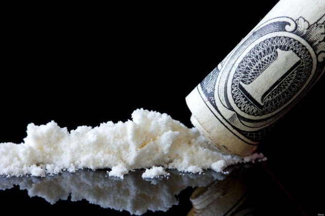 Cocaine and dollar with reflection on black background