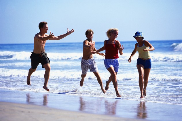 Young Men Chasing Young Women at Beach