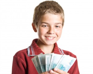 The young boy holds money in hands
