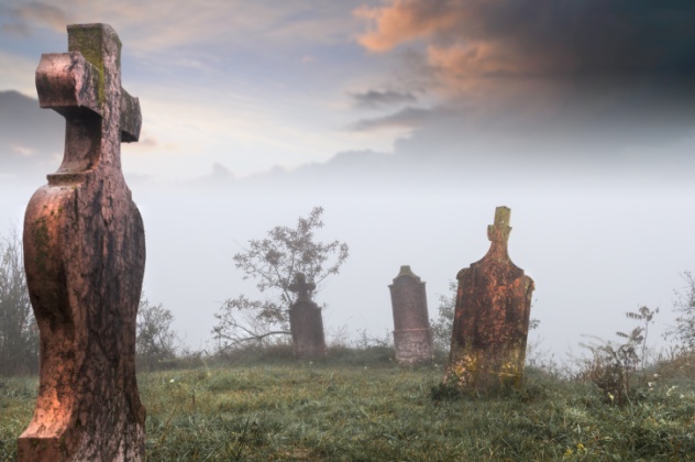 Old, abandoned cemetery  on a coldm foggy morning