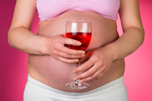 Pregnant woman with red wine