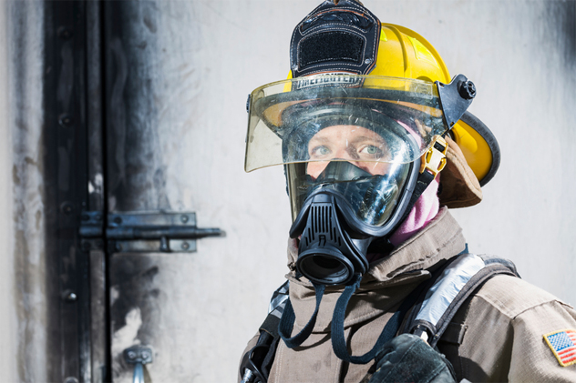 Female firefighter in protective gear and oxygen mask
