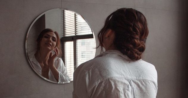 Hotel room mirror, hinting at something hidden behind it