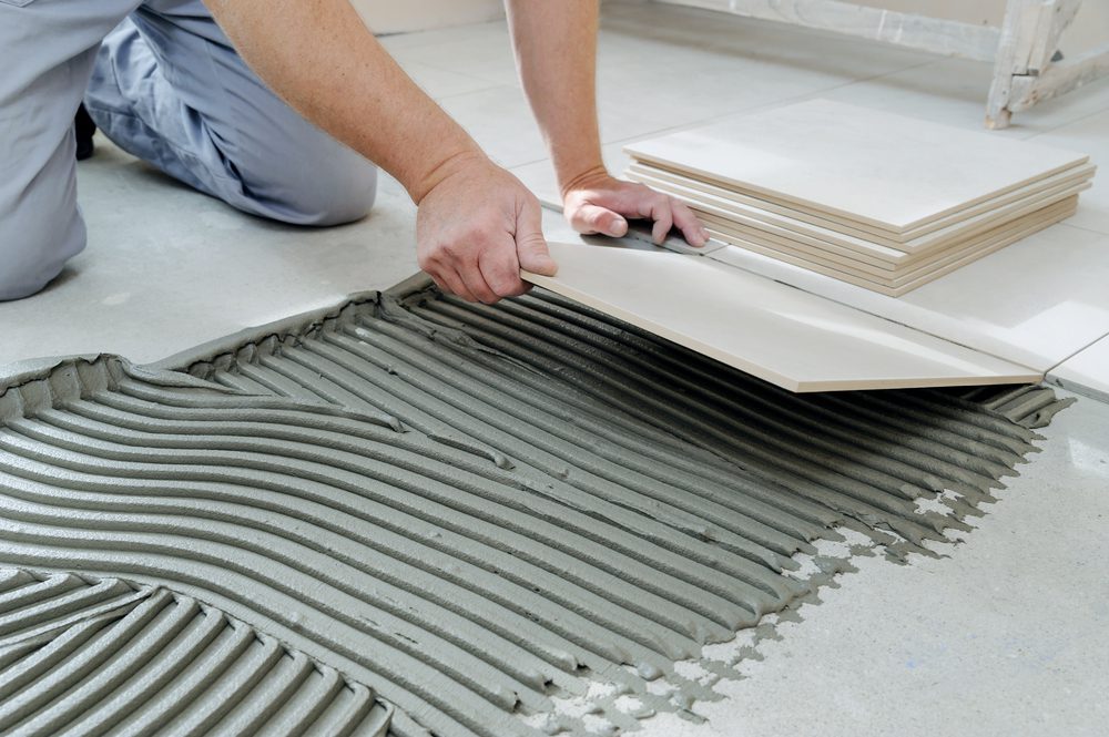 Tile installation in progress at a commercial site