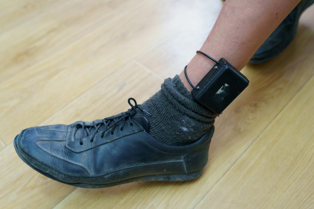 Ankle monitor attached to a prosthetic leg