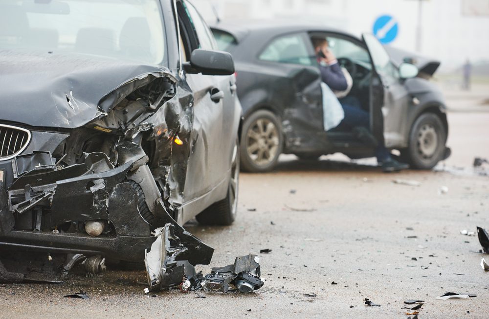 Image of a crashed car at night with a prosthetic arm nearby