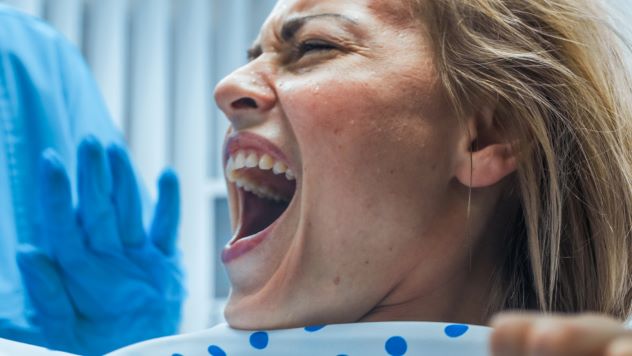 Woman screaming in a dark hallway, representing a suffering soul